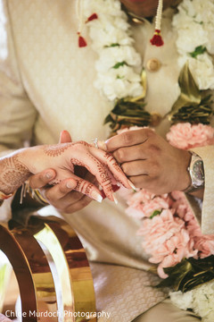 Indian groom putting ring to bride capture. Indian groom putting ring to bride capture.