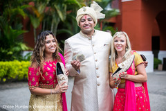Charming Indian groom with bridesmaids at mojaris game. Charming Indian groom with bridesmaids at mojaris game.