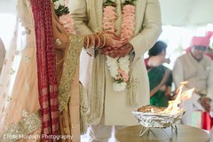 Indian bride and groom puring offerings to sacred fire. Indian bride and groom puring offerings to sacred fire.