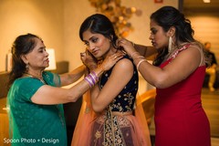 Indian bride getting ready with some extra help. Indian bride getting ready with some extra help.