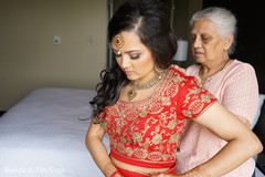 Maharani getting her open shirt lehenga on. Maharani getting her open shirt lehenga on.