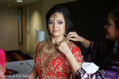 Lovely Indian bride putting on her ceremony jewelry. Lovely Indian bride putting on her ceremony jewelry.