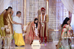 Indian bride pouring offerings to sacred fire at ceremony. Indian bride pouring offerings to sacred fire at ceremony.