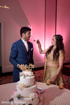 Indian newlyweds cutting the cake scene. Indian newlyweds cutting the cake scene.