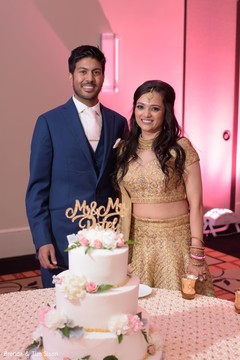 Indian lovebirds next to their wedding cake capture. Indian lovebirds next to their wedding cake capture.
