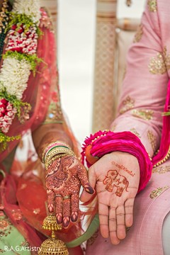 Indian bride and groom showing their mehndi Indian bride and groom showing their mehndi