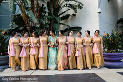 Indian bride and bridesmaids posing for an outdoor photo. Indian bride and bridesmaids posing for an outdoor photo.