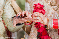 Indian bride placing the ring on Raja Indian bride placing the ring on Raja