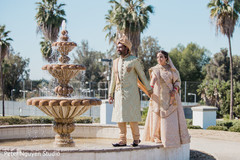 Indian bride and groom by the fountain Indian bride and groom by the fountain
