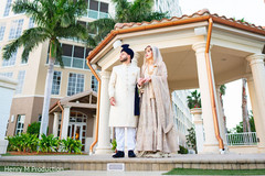 Indian bride and groom posing for pictures Indian bride and groom posing for pictures