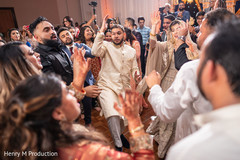 Indian newlyweds dancing with guests Indian newlyweds dancing with guests