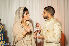 Indian bride and Raja sharing the cake Indian bride and Raja sharing the cake