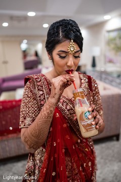 Lovely Indian bride having a drink capture. Lovely Indian bride having a drink capture.