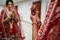 Sweet Indian bride putting her bangles on. Sweet Indian bride putting her bangles on.