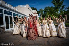 Joyful Indian bride with bridesmaids outdoors photo. Joyful Indian bride with bridesmaids outdoors photo.