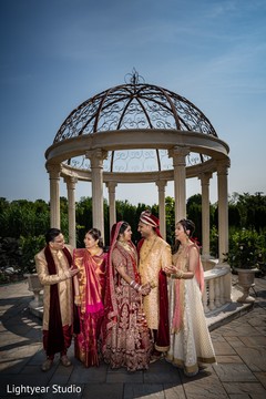 Marvelous Indian couple posing with relatives capture. Marvelous Indian couple posing with relatives capture.