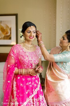 Indian bride being assisted by family guest Indian bride being assisted by family guest