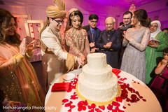 Cheerful Indian bride and groom cutting the cake. Cheerful Indian bride and groom cutting the cake.