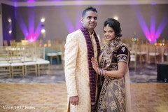 Indian bride and groom posing at the reception hall Indian bride and groom posing at the reception hall