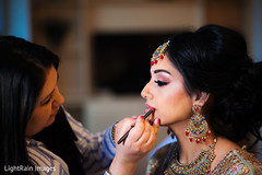Lovely Indian bride getting her hair and makeup done. Lovely Indian bride getting her hair and makeup done.