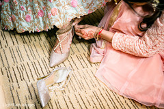 Indian bride being helped by putting her anklets Indian bride being helped by putting her anklets