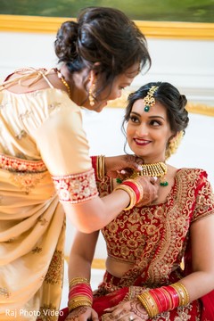 Amazing Indian bride being helped with the accessories Amazing Indian bride being helped with the accessories
