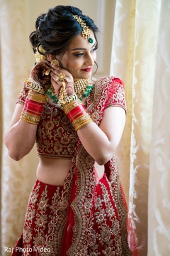 Indian bride putting earrings on Indian bride putting earrings on