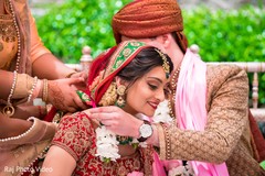Indian groom putting flower garland to bride Indian groom putting flower garland to bride