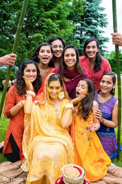 Indian bride and bridesmaids posing with their sangeet outfits. Indian bride and bridesmaids posing with their sangeet outfits.