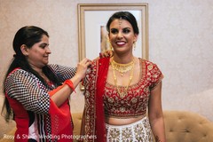 Indian groom being helped by parents to get ready Indian groom being helped by parents to get ready