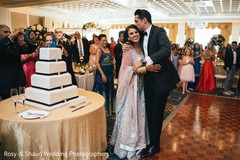 Lovely capture Indian bride and groom cutting cake together. Lovely capture Indian bride and groom cutting cake together.