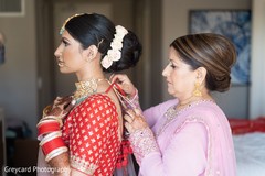 Maharani putting on her Polki necklace choker. Maharani putting on her Polki necklace choker.