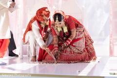 Indian couple pouring rice on to nuts. Indian couple pouring rice on to nuts.