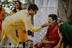 Indian groom getting turmeric paste on face. Indian groom getting turmeric paste on face.