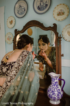 Lovely Indian bride putting her lipstick on. Lovely Indian bride putting her lipstick on.