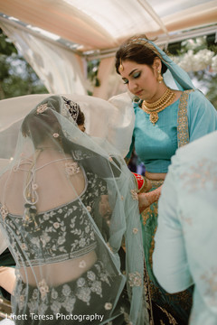 Indian bridesmaid helping bride. Indian bridesmaid helping bride.