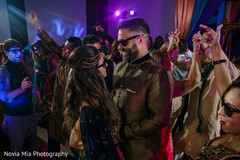 Joyful Indian bride and groom at their sangeet celebration Joyful Indian bride and groom at their sangeet celebration