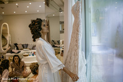 Lovely bride looking her wedding dress Lovely bride looking her wedding dress