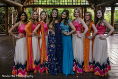 Indian bride and bridesmaids posing with their sangeet outfits. Indian bride and bridesmaids posing with their sangeet outfits.