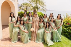 Enchanting Indian bride posing outdoors with bridesmaids. Enchanting Indian bride posing outdoors with bridesmaids.