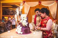 Lovely capture Indian bride and groom cutting cake together. Lovely capture Indian bride and groom cutting cake together.