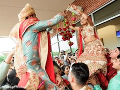 Enchanting Indian couple exchanging garlands at milni. Enchanting Indian couple exchanging garlands at milni.