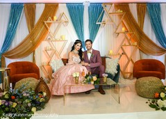 Elegant Indian couple posing at the reception stage. Elegant Indian couple posing at the reception stage.