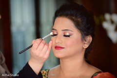 Indian bride getting her wedding makeup done Indian bride getting her wedding makeup done