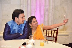Indian wedding guests taking a selfie capture. Indian wedding guests taking a selfie capture.