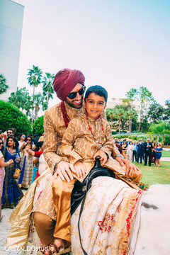 Indian groom with pageboy riding baraat horse. Indian groom with pageboy riding baraat horse.