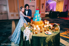 Lovely capture Indian bride and groom cutting cake together. Lovely capture Indian bride and groom cutting cake together.