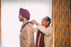 Indian groom being helped by parents getting ready. Indian groom being helped by parents getting ready.