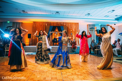 Indian bride and bridesmaids dancing with their sangeet outfits. Indian bride and bridesmaids dancing with their sangeet outfits.