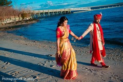 Couple holding hands by the beach Couple holding hands by the beach